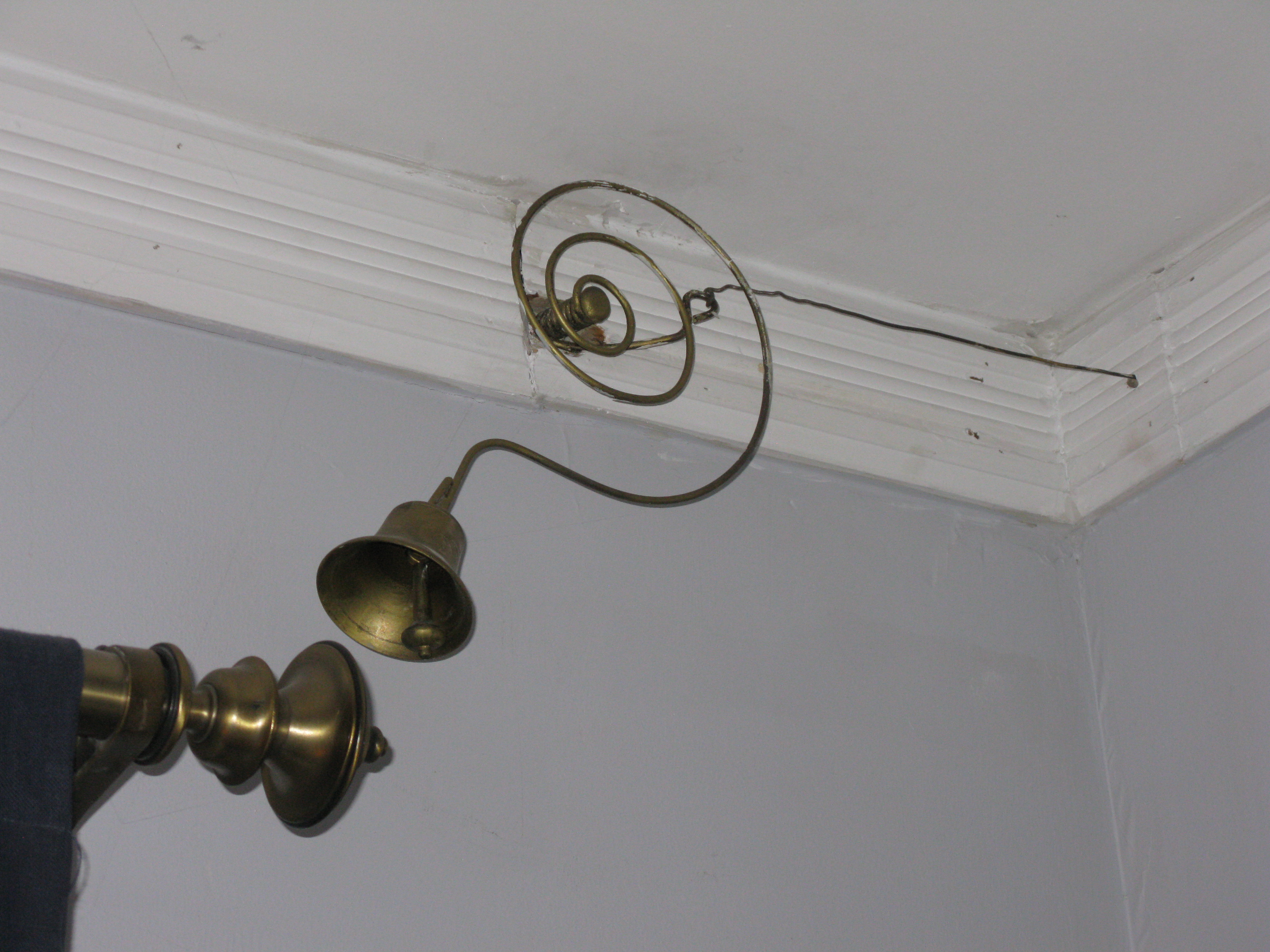 Antique door bell with original brass bell affixed to pull chain